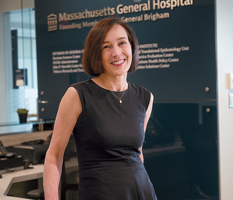 Physician Christine Ritchie smiling in front of a Massachusetts General Hospital sign.